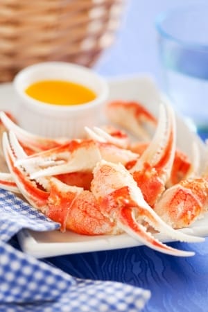 19798722 - boiled crab claws with orange sauce, selective focus