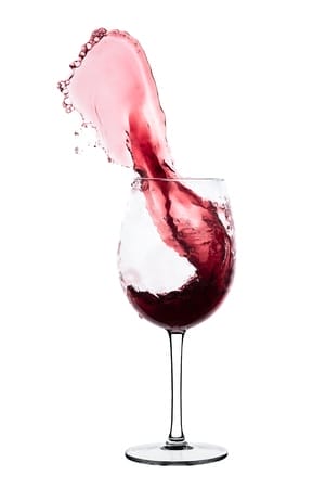 18360251 - red wine splashing out of a glass, isolated on white